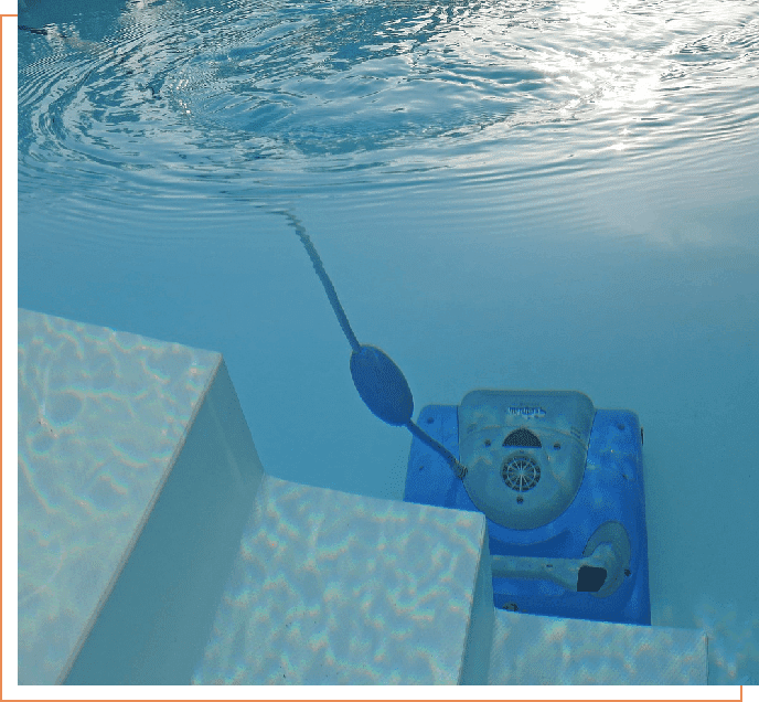 A pool cleaner is under water and has been placed in the pool.