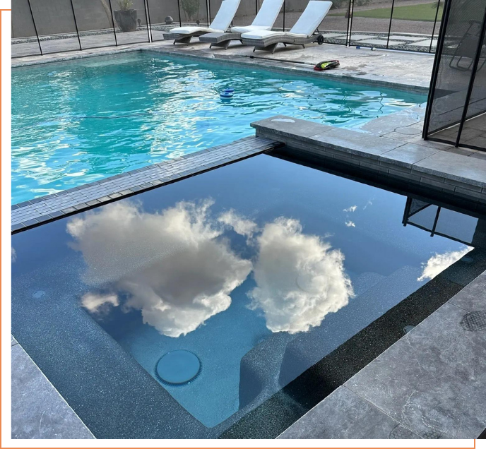 A pool with an open window and a cloudy sky reflected in it.